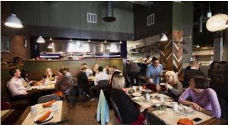 Busy Mexican restaurant full of happy customers enjoying dinner
